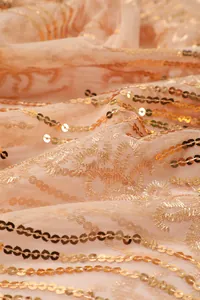 Close-up detail of high-end sunflower sequins and embroidery on mesh shawl fabric