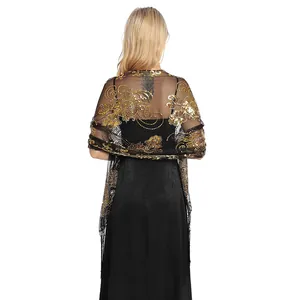 Back view of black sheer shawl with gold sequin flower embroidery and fringe