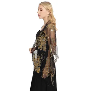 Detailed view of gold sequin embroidery on black mesh evening shawl scarf.