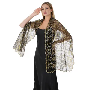 Close-up view of elegant gold sequin phoenix tail embroidery on black mesh wrap