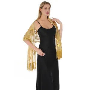 Detail of gold sequined evening shawl with elegant fringe for formal party dresses