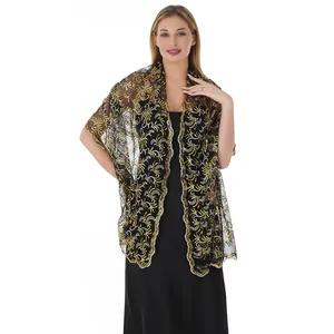 Detail view of an elegant black mesh shawl with gold phoenix tail sequin embroidery.