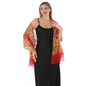 Detail view of sunflower sequin embroidered shawl with elegant red fringe tassels