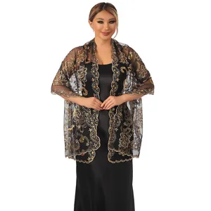 Detailed view of an elegant black lace shawl with golden lotus embroidery and shiny sequins