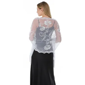 Detailed back view of white sequin embroidered shawl with elegant floral patterns and tassels