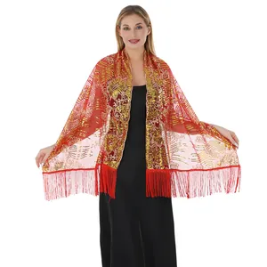 Close-up of elegant red shawl with gold sunflower sequin embroidery and long tassels