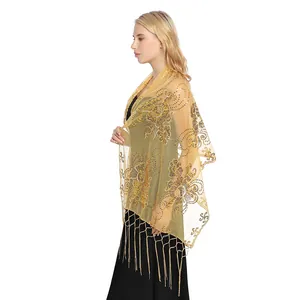 Detailed side view of a luxurious gold sequin flower shawl with long tassels on a model.