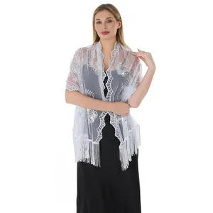 Detailed shot of white sequin embroidered lace shawl with fringe for evening gowns