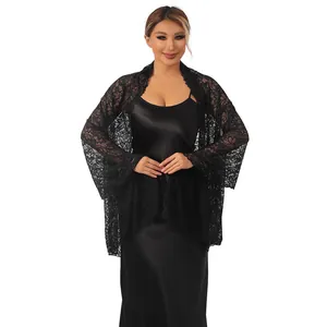 Elegant black lace shawl with sparkling rhinestones over a black satin evening dress