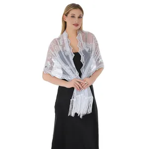 Detailed view of white sequin embroidered lace shawl with elegant tassel fringe