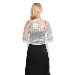 Detailed back view of a sheer silver sequin shawl with floral embroidery and tassels