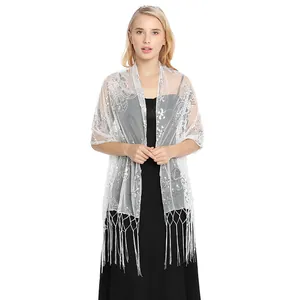 Detail view of a white sequin fringe shawl for evening party dresses and weddings.