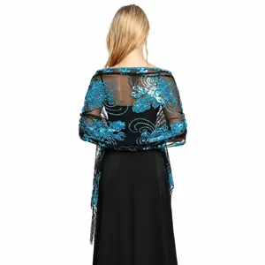 Detailed back view of black mesh shawl with turquoise sequin floral embroidery and fringe.