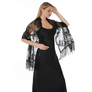 Detailed view of elegant black lace shawl with floral sequin embroidery and fringe