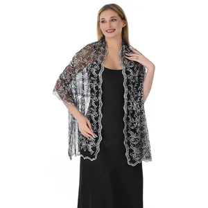 Detailed view of elegant phoenix tail sequin embroidery on black lace bridal shawl wrap