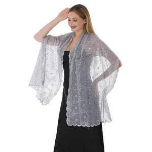Close-up detail of elegant silver floral sequin embroidery lace shawl for wedding guest