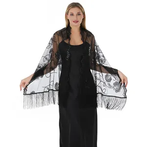 Detailed view of black lace shawl with sparkling sequins and elegant fringe trim