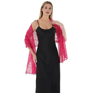 Detail showing the pink plum blossom sequin embroidery on an elegant lace shawl