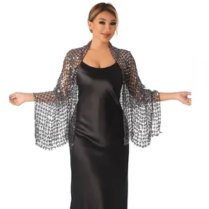 Detailed look at the shimmering sequin mesh shawl worn over a black satin evening dress