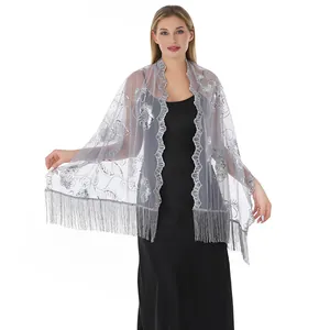 Close-up of elegant silver sequin embroidered evening shawl with tassel fringe