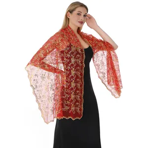 Detail view of an elegant red mesh shawl with intricate gold sequin embroidery