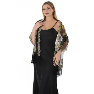 Detailed look of black sheer wedding evening shawl with gold embroidery and fringes