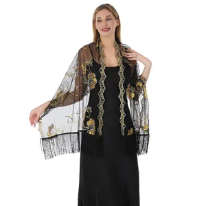 Detail showing gold sequin embroidery and black fringe on elegant evening shawl