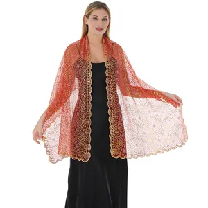 Detailed view of elegant red lace shawl with gold plum blossom sequins for evening gowns