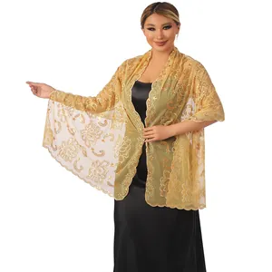 Detail of elegant gold embroidered shawl with sequins for wedding guest evening dress