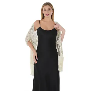 Detailed view of sequin sunflower embroidery and long tassels on an elegant shawl