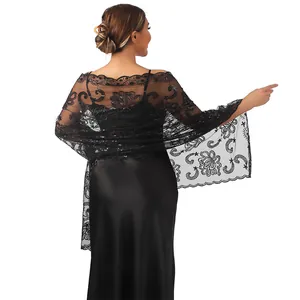 Detail view of black floral lace shawl with sequins worn over an evening dress