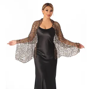A detailed macro view of shimmering sequins on an elegant black mesh evening shawl wrap