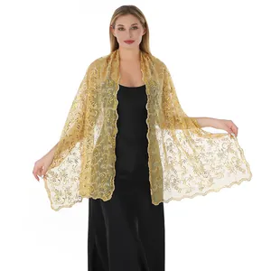 Detail view of the elegant gold phoenix tail sequin embroidery on mesh shawl.