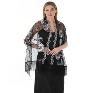 Detailed view of black mesh evening shawl with silver sequin floral embroidery and fringe