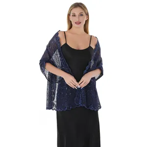 Detail showing an elegant navy blue sequin lace shawl paired with a black dress