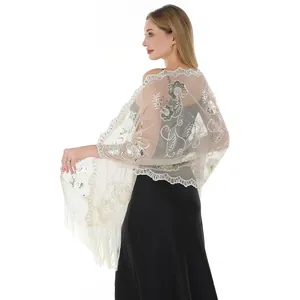 Detail of sequin embroidered evening shawl with floral patterns and elegant tassels.