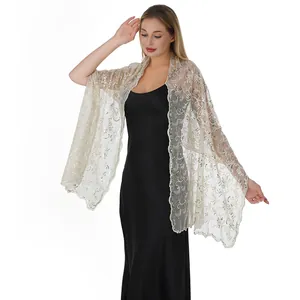 Detail view of champagne sequin embroidered shawl with phoenix tail pattern on model