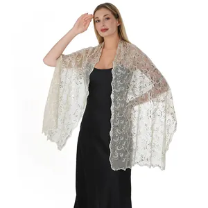 Close-up of elegant champagne sequin lace shawl with phoenix tail embroidery detail