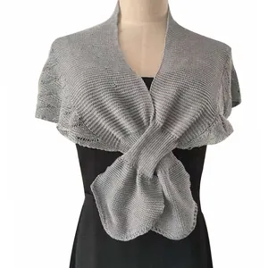 Detailed texture of grey thin knit shawl featuring an elegant fishtail hem design
