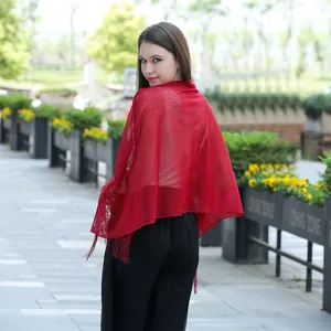Elegant red lace wedding shawl with tassel details shown on a model from the back