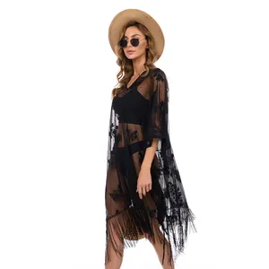 Elegant plus size black lace beach cover up with fringe tassels on a female model