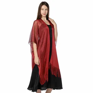 Detailed view of red shimmering metallic shawl with elegant fringe tassels