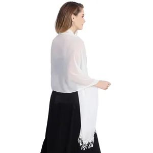 Detailed view of white chiffon bridal shawl with elegant lace fringe trim