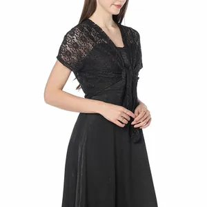 Detailed macro view of black floral lace shrug with tie-front design on a model