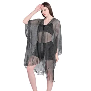 Detailed view of black metallic shimmer kaftan with long fringe hem and batwing sleeves