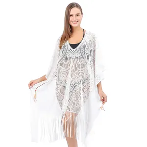 Detail view of white lace beach cover up with tassels