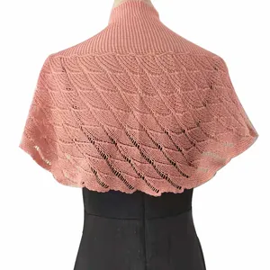 Elegant pink knitted lace capelet shawl showcasing intricate wave patterns from behind