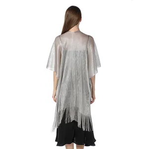 Detailed back view of a silver metallic glitter shawl with fringe hem on a model