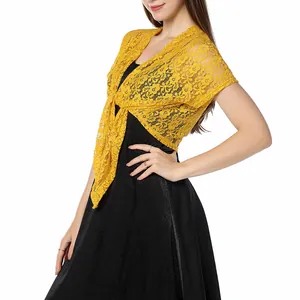 Elegant yellow floral lace shrug bolero tied over a stylish black evening dress