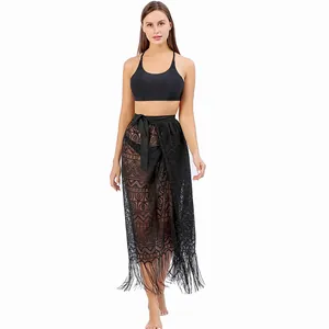 Full-body detail showing a black lace beach sarong wrap with elegant fringe tassels on a model